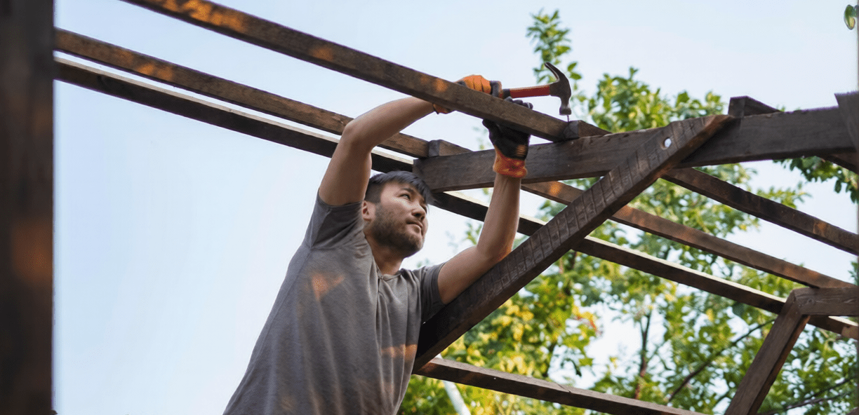 man installing pergola